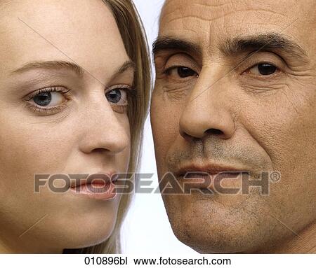 close-up portrait of mature man and young woman looking serious View Large Photo Image Stock Image - close-up portrait of mature man and young woman looking serious. Fotosearch