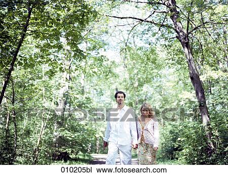 couple enjoying walk in the park View Large Photo Image Stock Image - couple enjoying walk in the park. Fotosearch