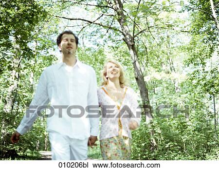 couple enjoying walk in the park (blurred image! ) View Large Photo Image Stock Image - couple enjoying walk in the park (blurred image! ). Fotosearch