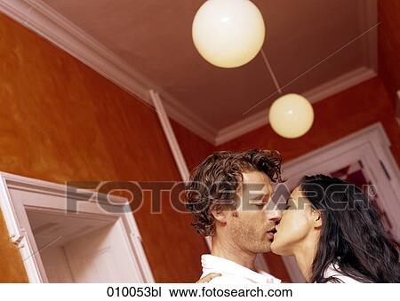 couple in appartment corridor kissing each other View Large Photo Image Stock Image - couple in appartment corridor kissing each other. Fotosearch