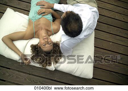 couple lying on pillows on veranda View Large Photo Image Stock Image - couple lying on pillows on veranda. Fotosearch