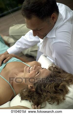 couple lying on pillows on veranda View Large Photo Image Stock Image - couple lying on pillows on veranda. Fotosearch