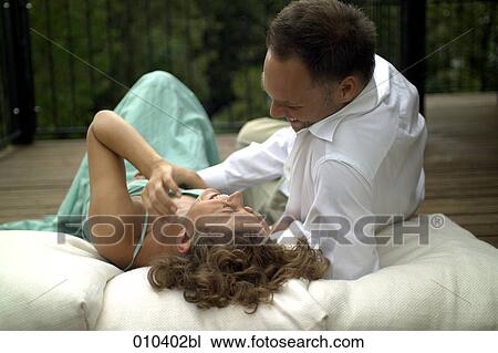 couple lying on pillows on veranda View Large Photo Image Stock Image - couple lying on pillows on veranda. Fotosearch
