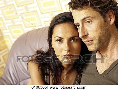 couple on grey leather sofa looking serious View Large Photo Image Stock Image - couple on grey leather sofa looking serious. Fotosearch