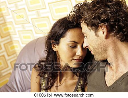 couple on grey sofa feeling comfortable with each other View Large Photo Image Stock Image - couple on grey sofa feeling comfortable with each other. Fotosearch