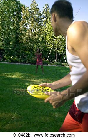 couple playing frisbee in garden View Large Photo Image Stock Image - couple playing frisbee in garden. Fotosearch