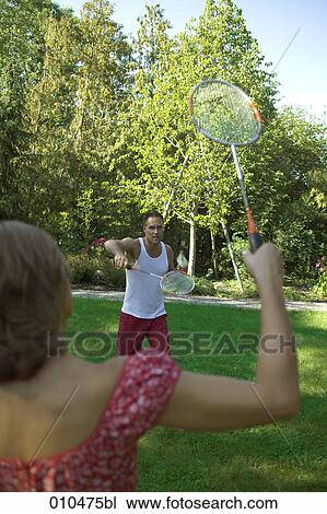 couple playing in garden playing badminton View Large Photo Image Stock Image - couple playing in garden playing badminton. Fotosearch