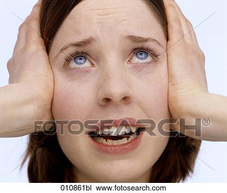 Desperate looking young woman covering her ears with the hands View Large Photo Image Stock Image - Desperate looking young woman covering her ears with the hands. Fotosearch