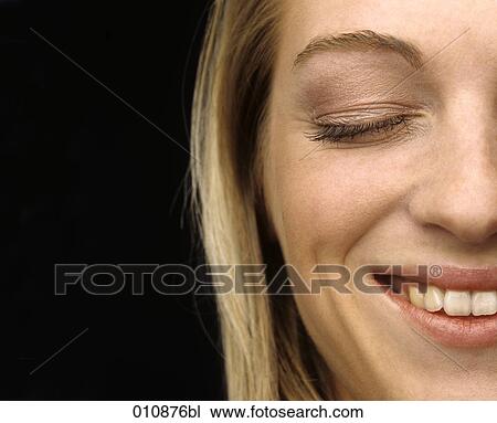 Stock Image - Detail of smiling young woman´s face. Fotosearch
