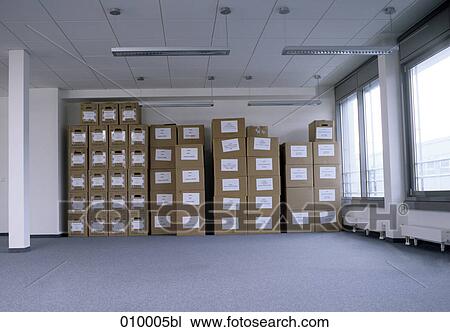 empty office space with neatly stacked moving boxes in background View Large Photo Image Stock Image - empty office space with neatly stacked moving boxes in background. Fotosearch