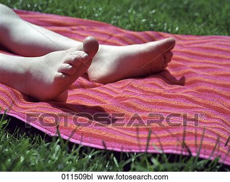 feet of child relaxing on towel in grass View Large Photo Image Stock Image - feet of child relaxing on towel in grass. Fotosearch