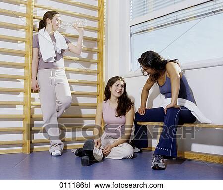 Stock Image - Female group relaxing in gym. Fotosearch