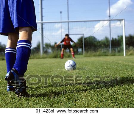 Stock Image - fooball player waiting to shoot penalty. Fotosearch