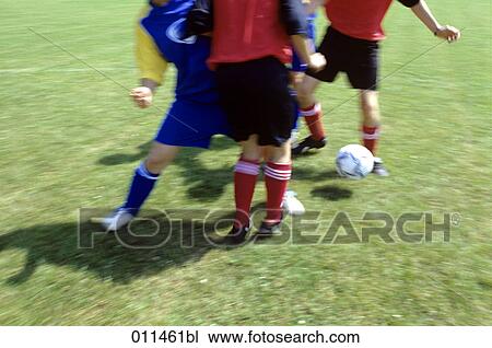 Stock Image - football players tackling their opponents. Fotosearch