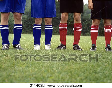 four football players standing in line View Large Photo Image Stock Image - four football players standing in line. Fotosearch