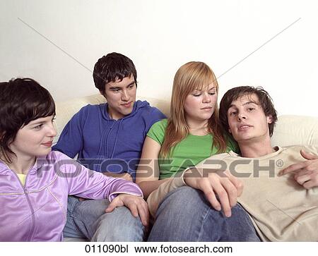 Stock Image - Four friends sitting together. Fotosearch
