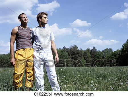 fully body portrait of gay couple (20-25 years) standing in the grass View Large Photo Image Stock Image - fully body portrait of gay couple (20-25 years) standing in the grass. Fotosearch