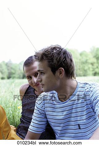 Stock Image - gay couple (20-25 years) enjoying an afternoon in the park. Fotosearch
