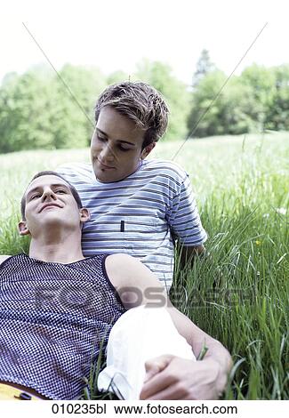 Stock Image - gay couple (20-25 years) enjoying an afternoon in the park. Fotosearch