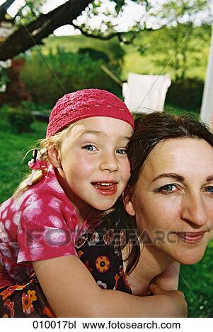 girl hanging on her mother´s shoulders View Large Photo Image Stock Image - girl hanging on her mother´s shoulders. Fotosearch