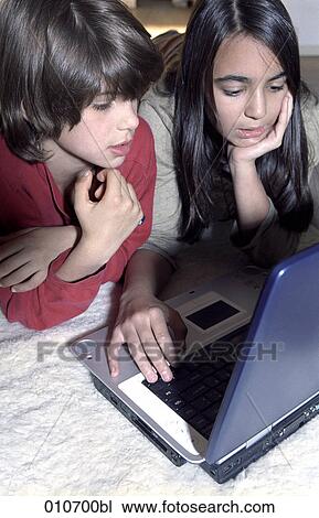 girl showing boy how to work with a notebook computer View Large Photo Image Stock Image - girl showing boy how to work with a notebook computer. Fotosearch