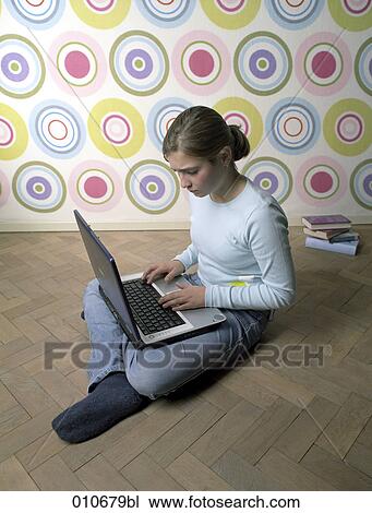 girl sitting on the floor, working with notebook computer View Large Photo Image Stock Image - girl sitting on the floor, working with notebook computer. Fotosearch