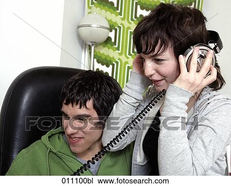 Girl wearing headphones and listening to music View Large Photo Image Stock Image - Girl wearing headphones and listening to music. Fotosearch