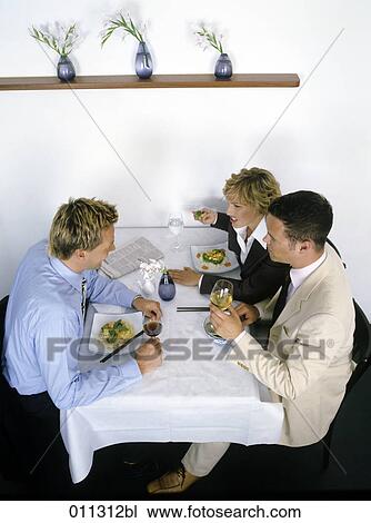 Stock Image - group at business lunch having a controversial conversation. Fotosearch