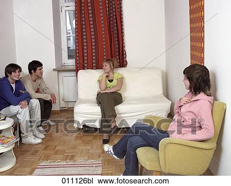 Group of friends sitting together and talking to each other View Large Photo Image Stock Image - Group of friends sitting together and talking to each other. Fotosearch