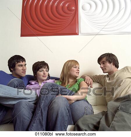 Group of friends sitting together View Large Photo Image Stock Image - Group of friends sitting together. Fotosearch