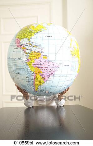 Stock Image - hands holding an inflatable globe. Fotosearch