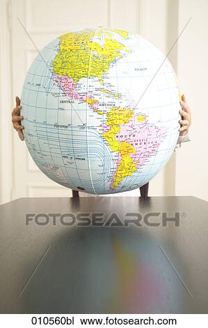 hands holding an inflatable globe View Large Photo Image Stock Image - hands holding an inflatable globe. Fotosearch
