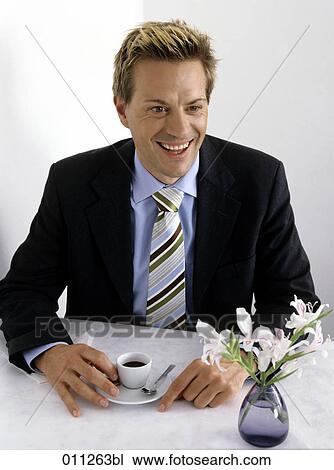 laughing businessman having a cup of coffee View Large Photo Image Stock Image - laughing businessman having a cup of coffee. Fotosearch