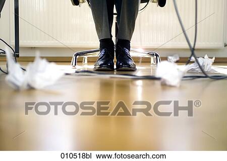legs of businessman under the table with crumpled paper lying on the floor View Large Photo Image Stock Image - legs of businessman under the table with crumpled paper lying on the floor. Fotosearch