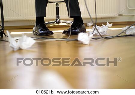 legs of businessman under the table with crumpled paper lying on the floor View Large Photo Image Stock Image - legs of businessman under the table with crumpled paper lying on the floor. Fotosearch