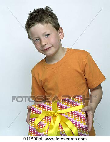 little boy holding gift in his hands View Large Photo Image Stock Image - little boy holding gift in his hands. Fotosearch