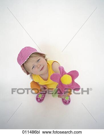 little girl with pink hat offering toy in form of flower View Large Photo Image Stock Image - little girl with pink hat offering toy in form of flower. Fotosearch