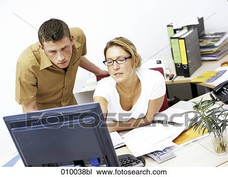 male and female office workers looking at flat panel monitor View Large Photo Image Stock Image - male and female office workers looking at flat panel monitor. Fotosearch