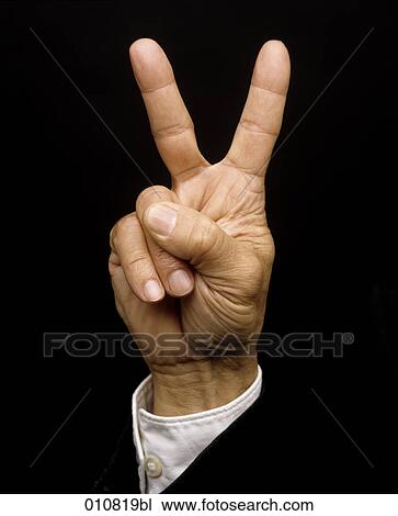 Stock Image - Male hand showing the victory sign. Fotosearch