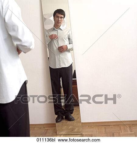 Male teenager buttoning his white shirt View Large Photo Image Stock Image - Male teenager buttoning his white shirt. Fotosearch