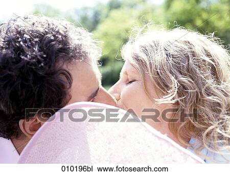 man and woman kissing each other View Large Photo Image Stock Image - man and woman kissing each other. Fotosearch