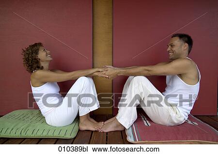 Stock Image - man and woman relaxing on veranda. Fotosearch