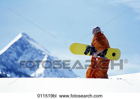 man dressed as buddhist monk carrying snowboard in alpine landscape View Large Photo Image Stock Image - man dressed as buddhist monk carrying snowboard in alpine landscape. Fotosearch