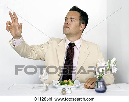 man in restaurant raising his arm to call the waiter View Large Photo Image Stock Image - man in restaurant raising his arm to call the waiter. Fotosearch