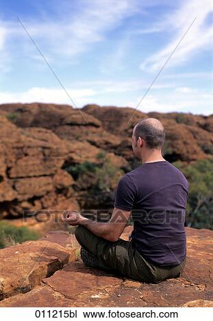 man meditating by a canyon View Large Photo Image Stock Image - man meditating by a canyon. Fotosearch