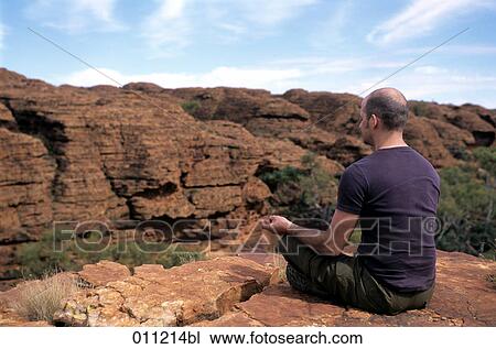 man meditating in open landscape View Large Photo Image Stock Image - man meditating in open landscape. Fotosearch