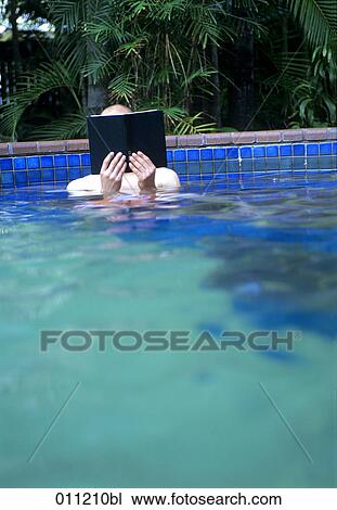man reading book in swimming pool View Large Photo Image Stock Image - man reading book in swimming pool. Fotosearch