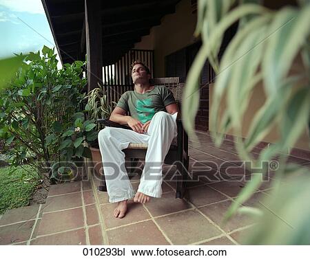man relaxing in rocking chair on veranda View Large Photo Image Stock Image - man relaxing in rocking chair on veranda. Fotosearch