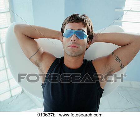 man relaxing with a gelmask over his eyes View Large Photo Image Stock Image - man relaxing with a gelmask over his eyes. Fotosearch