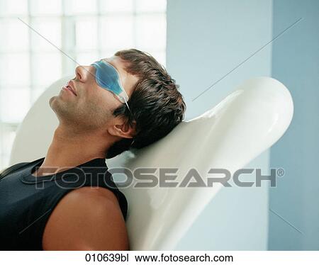 man relaxing with a gelmask over his eyes View Large Photo Image Stock Image - man relaxing with a gelmask over his eyes. Fotosearch